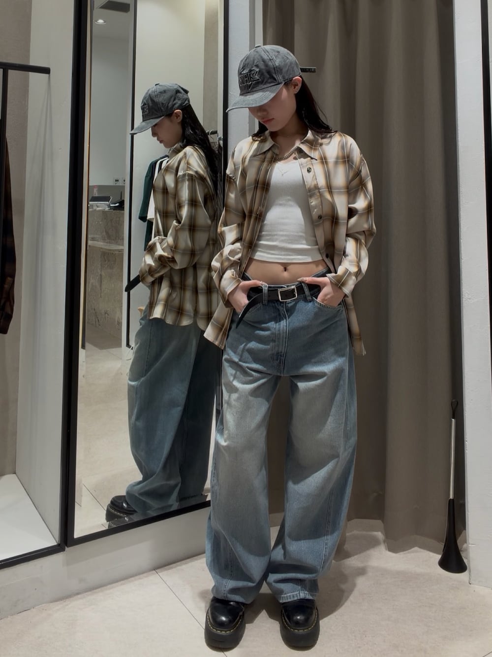 ブルー系のデニムパンツ、ホワイト系のシャツ/ブラウス、ブラック系のショルダーバッグを着用したレディースの春コーディネートの5枚目の写真