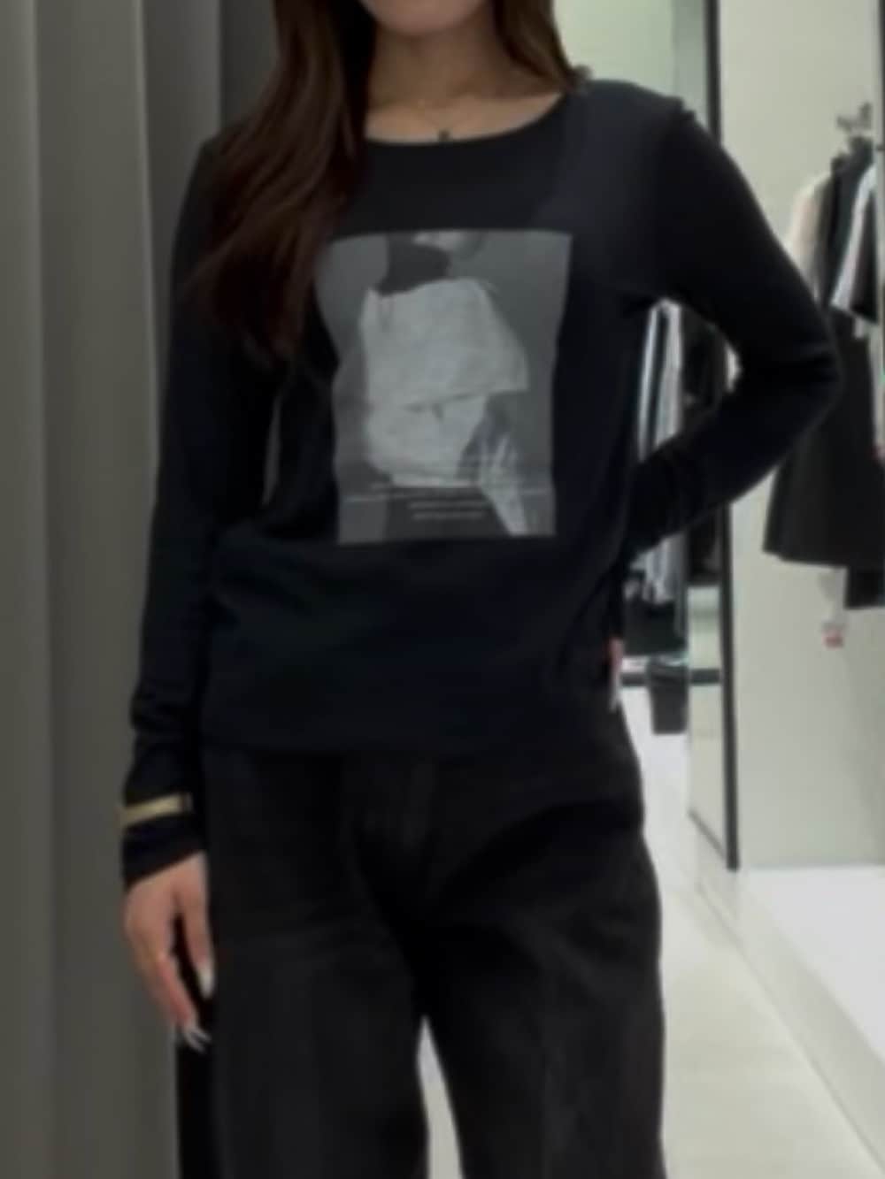 ブラック系のデニムパンツ、ブラック系のTシャツ/カットソー、ブラック系のベルトを着用したレディースの秋コーディネートの4枚目の写真