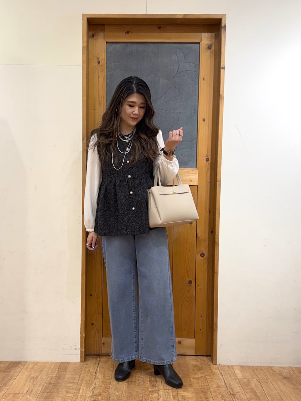 ブラック系のシャツ/ブラウス、ブルー系のデニムパンツを着用したレディースの冬コーディネートの3枚目の写真