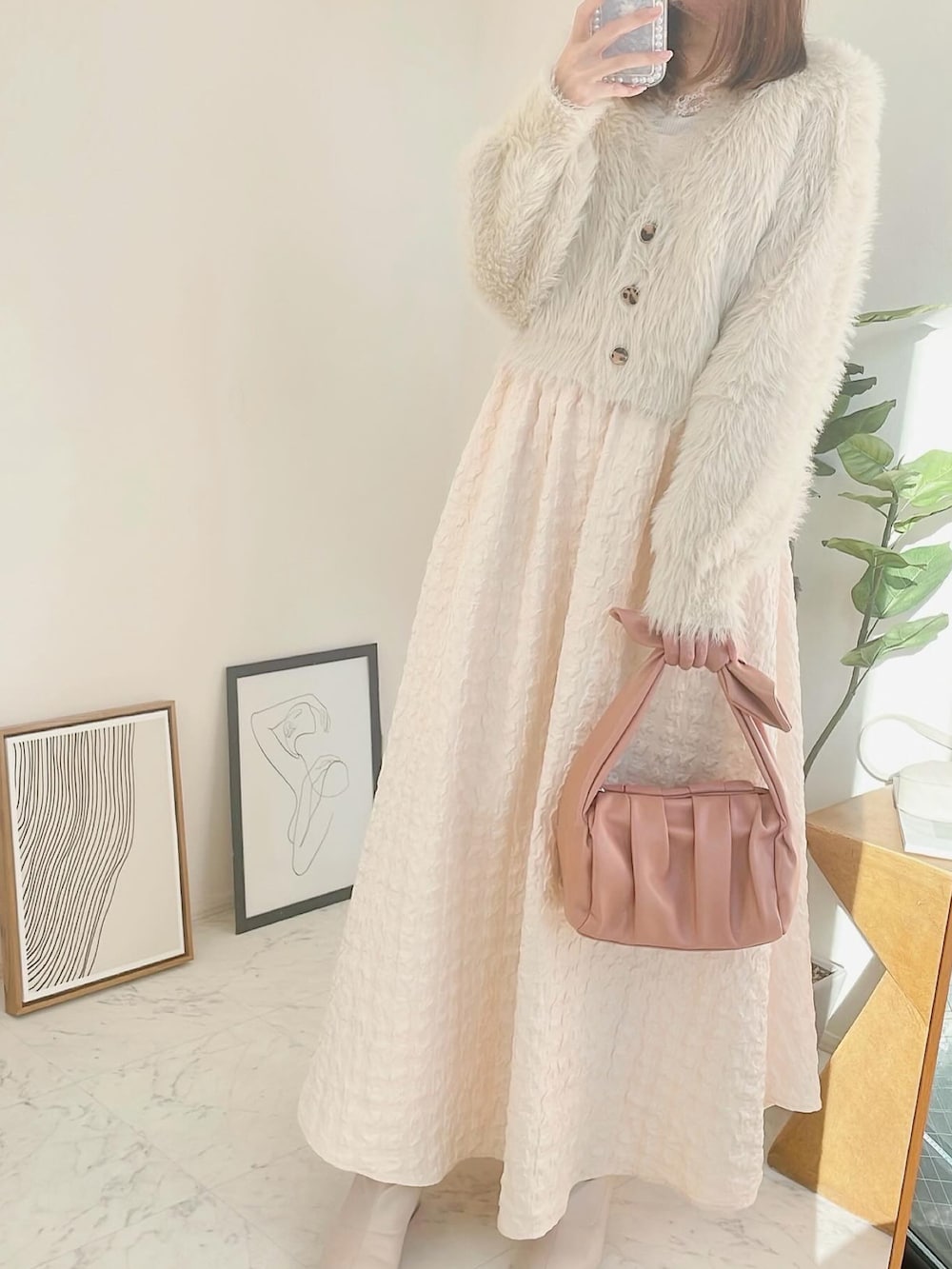 ホワイト系のカーディガン/ボレロ、ホワイト系のドレス、ピンク系のショルダーバッグを着用したレディースの冬コーディネートの2枚目の写真