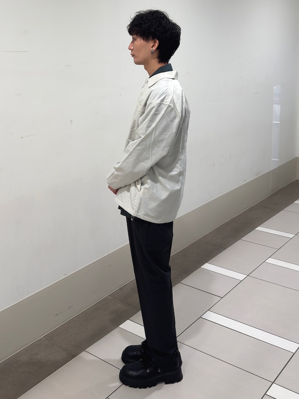 ホワイト系のその他アウター、グリーン系のカバーオール、グレー系のその他パンツを着用したメンズの春コーディネートの2枚目の写真