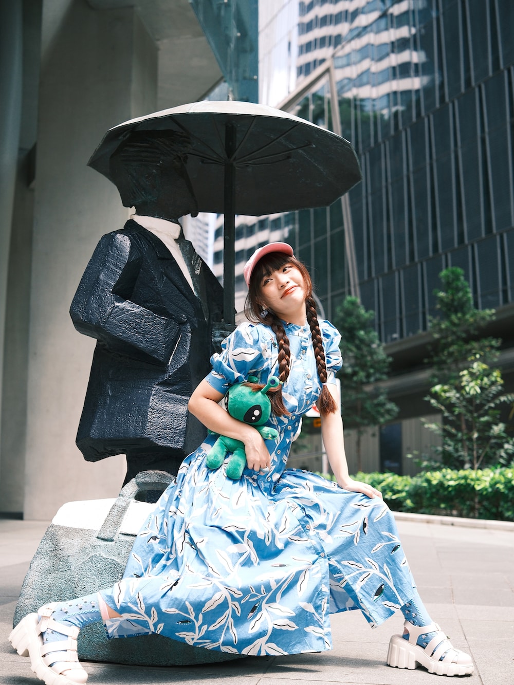 ブルー系のワンピース、ホワイト系のサンダル、ピンク系のキャップを着用したレディースの冬コーディネートの3枚目の写真