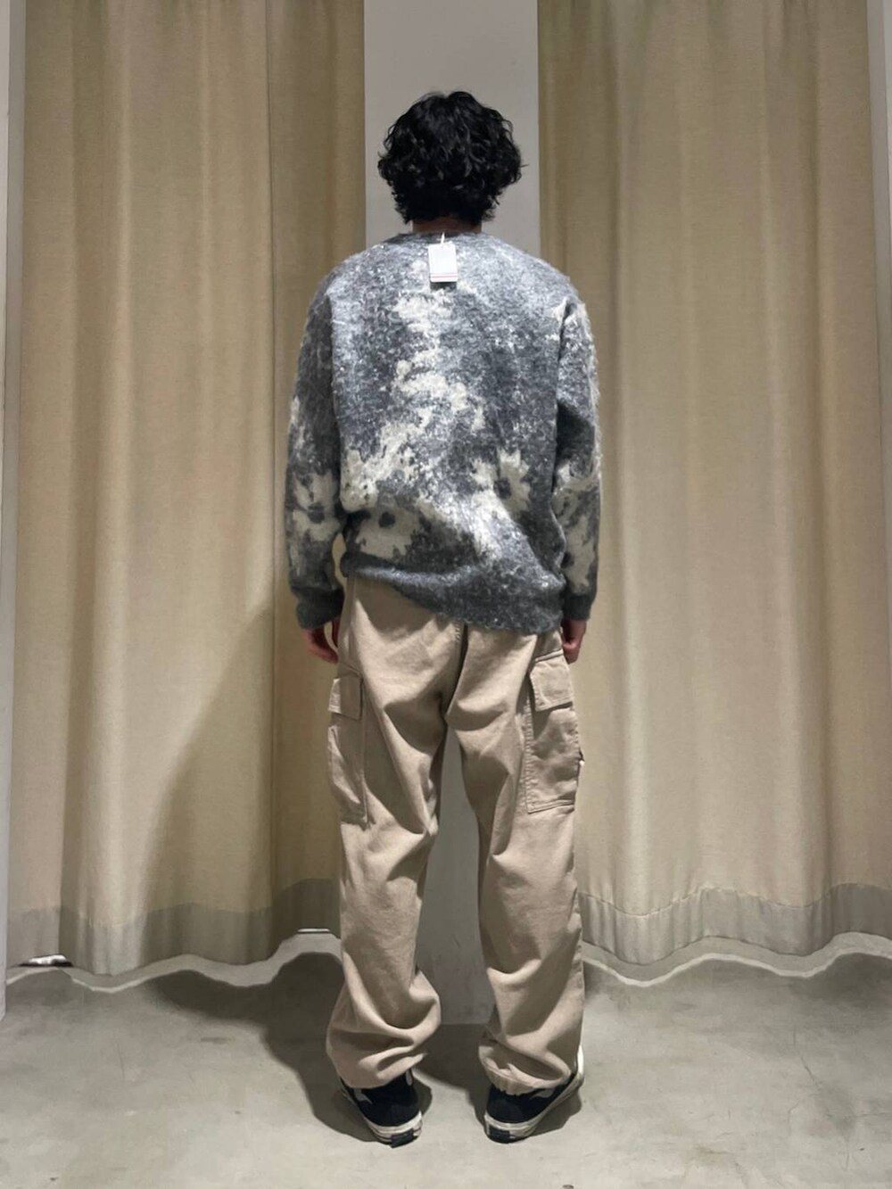 ベージュ系のカーゴパンツ、グレー系のニット/セーターを着用したメンズの秋コーディネートの4枚目の写真