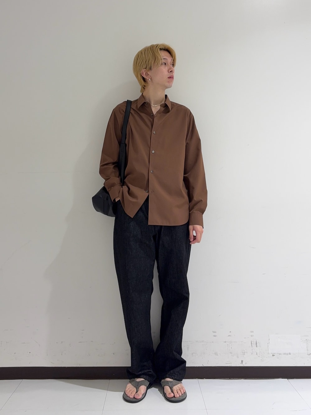 ブラウン系のシャツ/ブラウス、ブラック系のデニムパンツ、グレー系のサンダルを着用したメンズの秋コーディネートの3枚目の写真