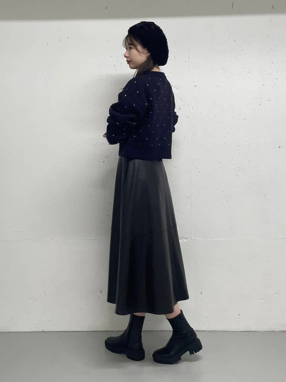 ブラック系のスカート、ブルー系のカーディガン/ボレロを着用したレディースの秋コーディネートの2枚目の写真