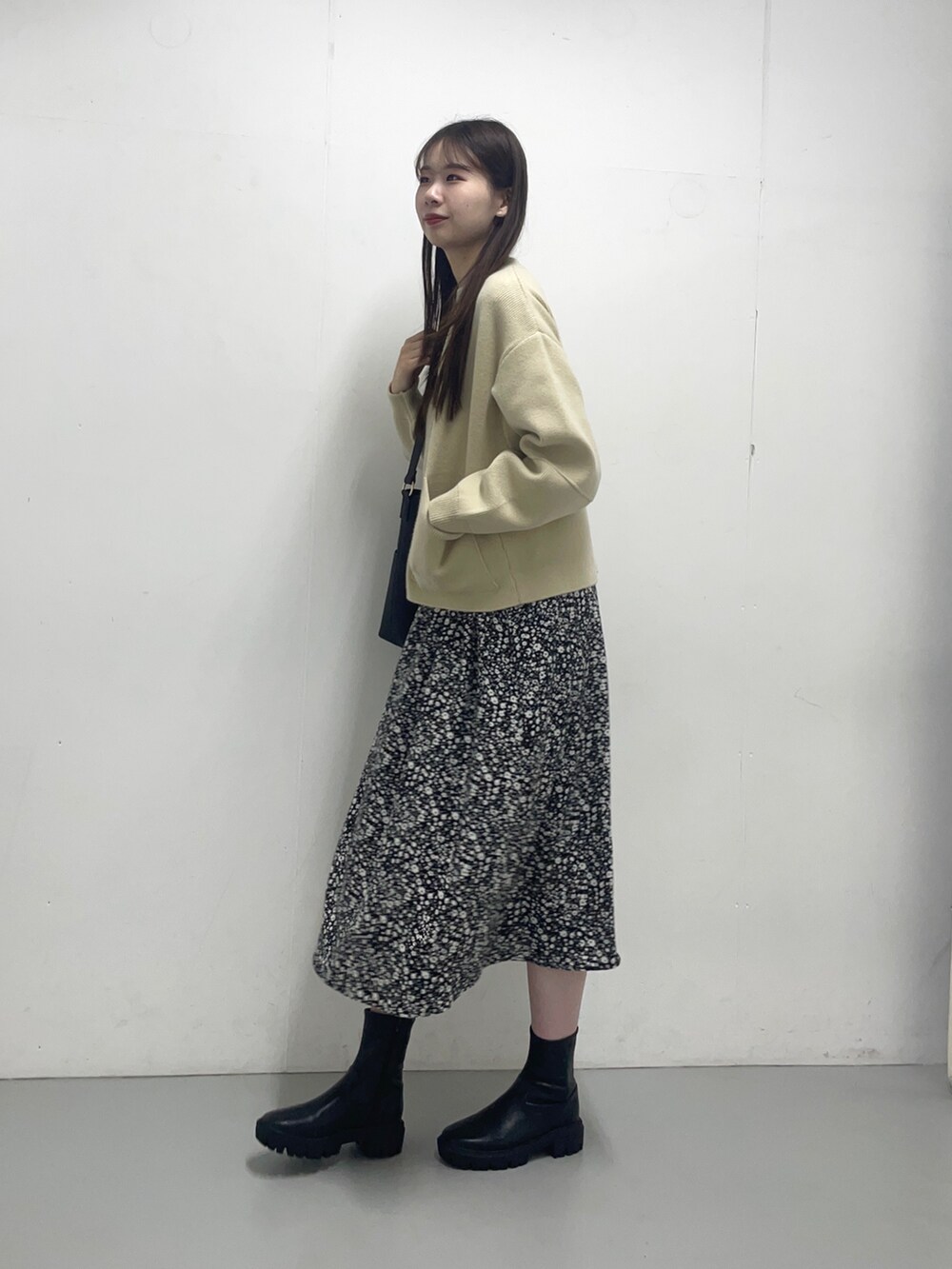 ベージュ系のブルゾン、ブラック系のワンピースを着用したレディースの秋コーディネートの2枚目の写真