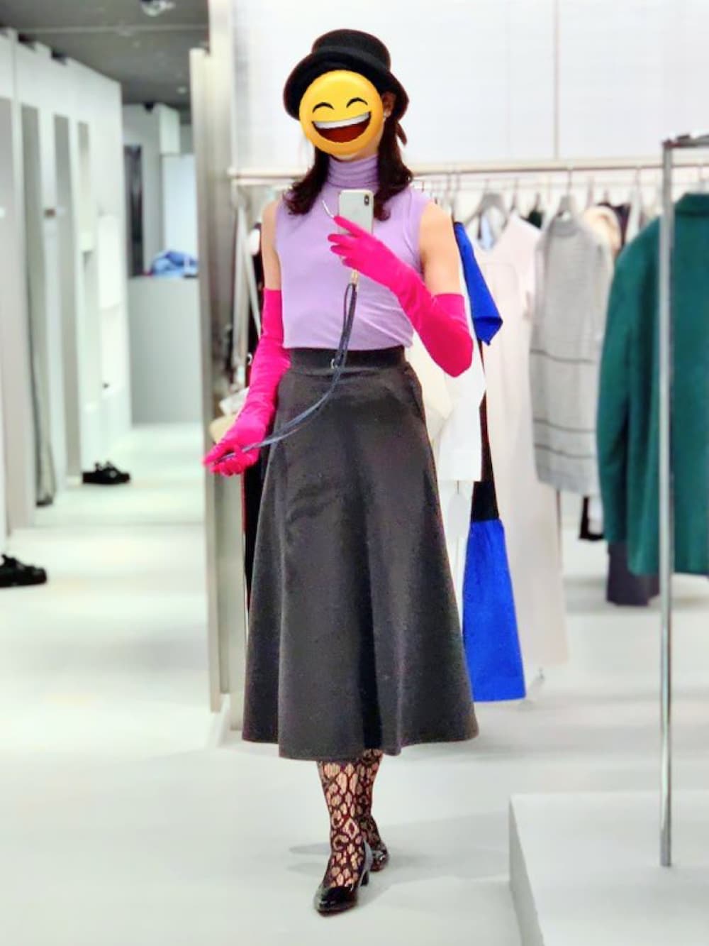 パープル系のトップス、グレー系のスカート、ブラック系のパンプスを着用したレディースの夏コーディネートの5枚目の写真