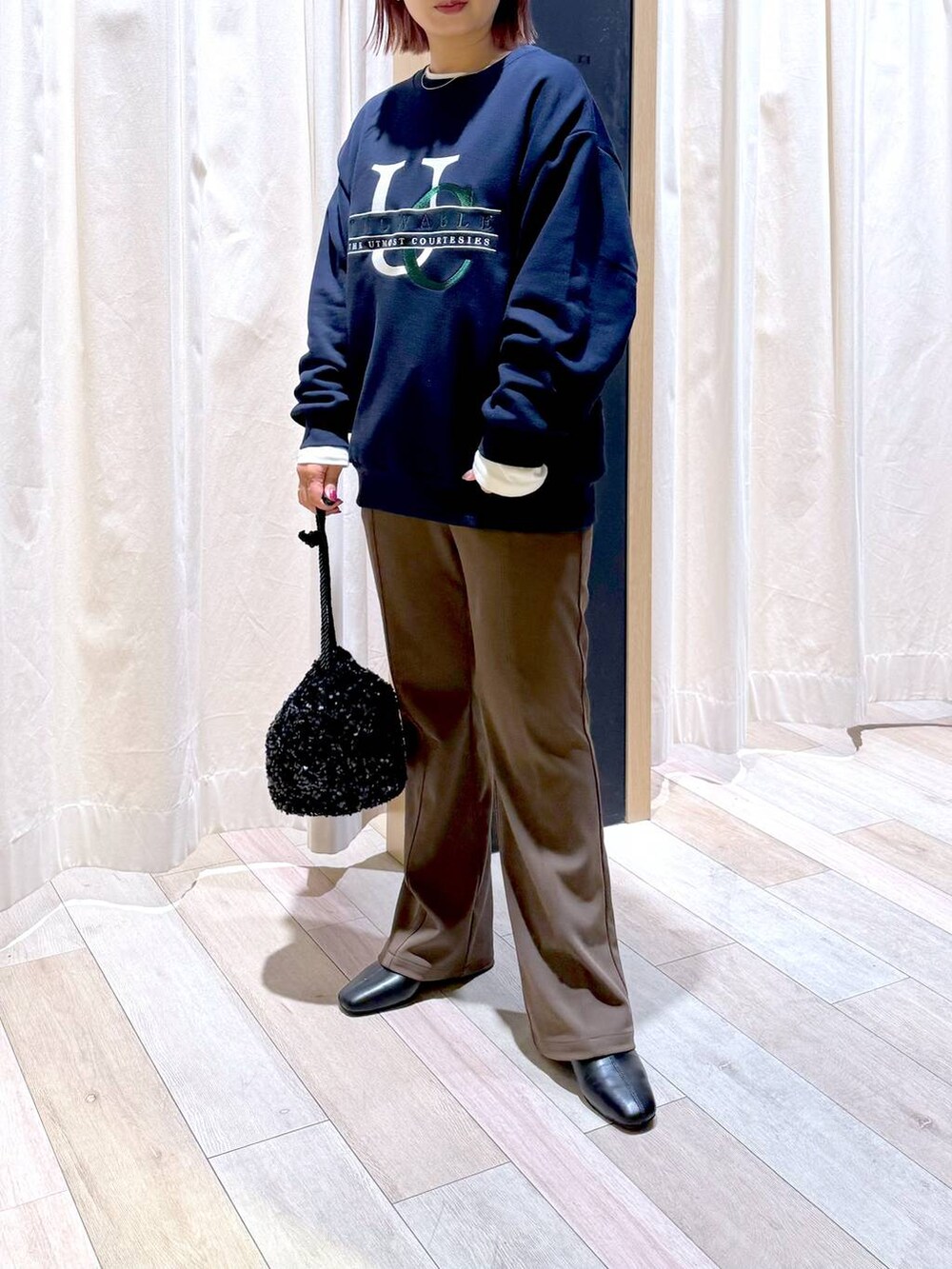 ブラウン系のその他パンツ、ホワイト系のTシャツ/カットソー、ブラック系のブーツを着用したレディースの冬コーディネートの2枚目の写真