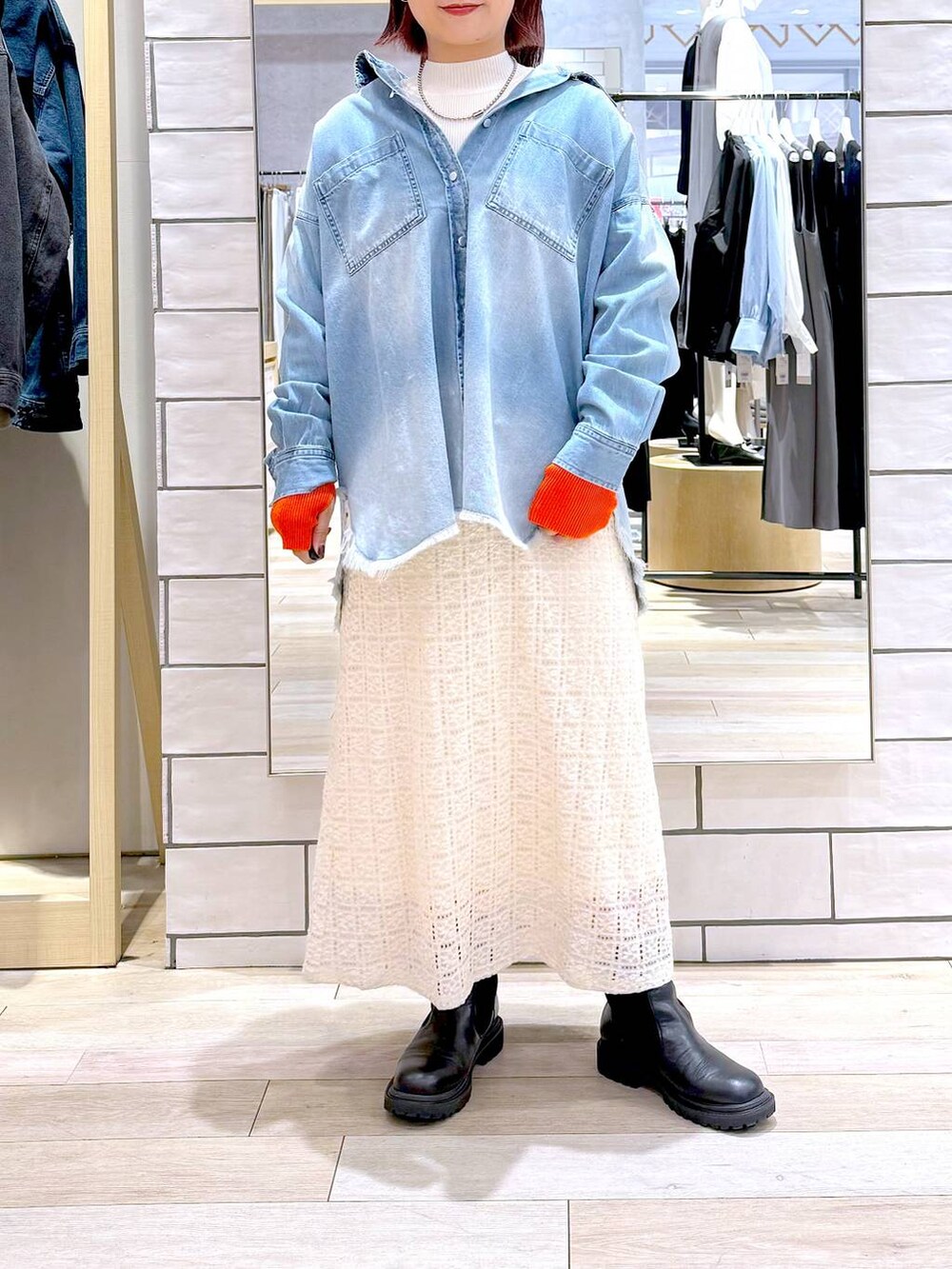 ブルー系のシャツ/ブラウス、ホワイト系のニット/セーター、ホワイト系のスカートを着用したレディースの冬コーディネートの2枚目の写真