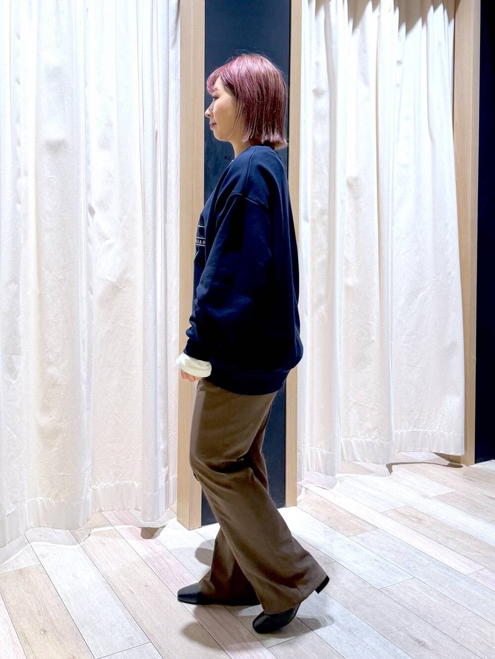 ブラウン系のその他パンツ、ホワイト系のTシャツ/カットソー、ブラック系のブーツを着用したレディースの冬コーディネートの5枚目の写真