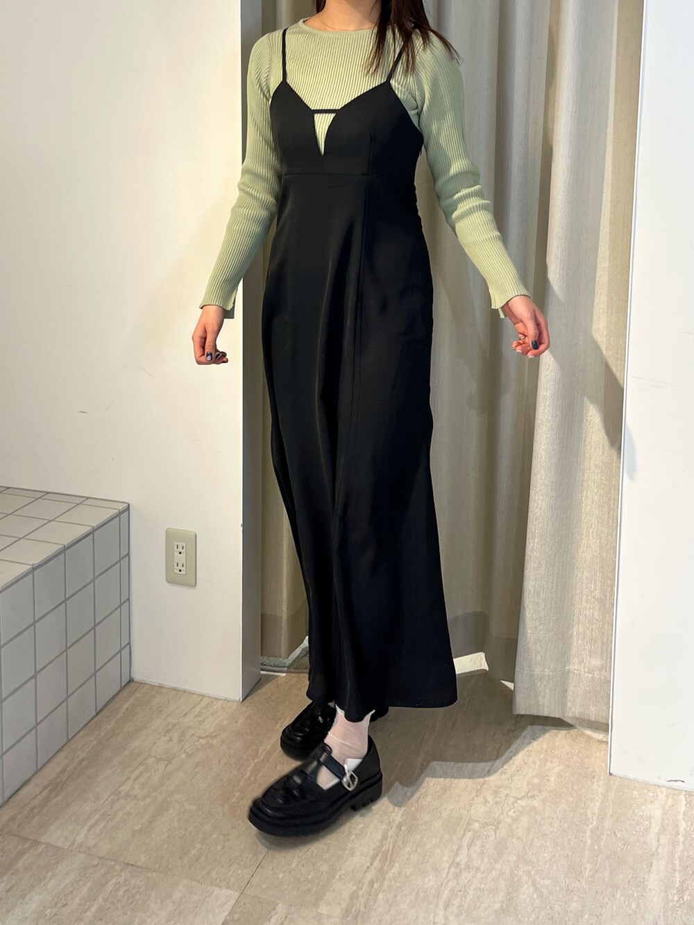 グリーン系のニット/セーター、グリーン系のワンピース、ブラック系のローファーを着用したレディースの冬コーディネートの3枚目の写真