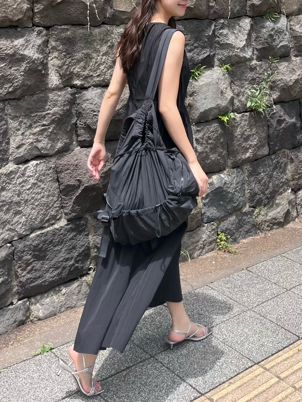 ブラック系のワンピースを着用したレディースの夏コーディネートの3枚目の写真