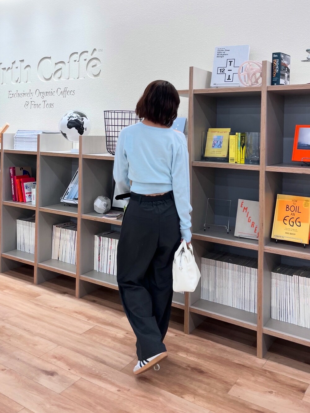 ブルー系のニット/セーターを着用したレディースの春コーディネートの2枚目の写真