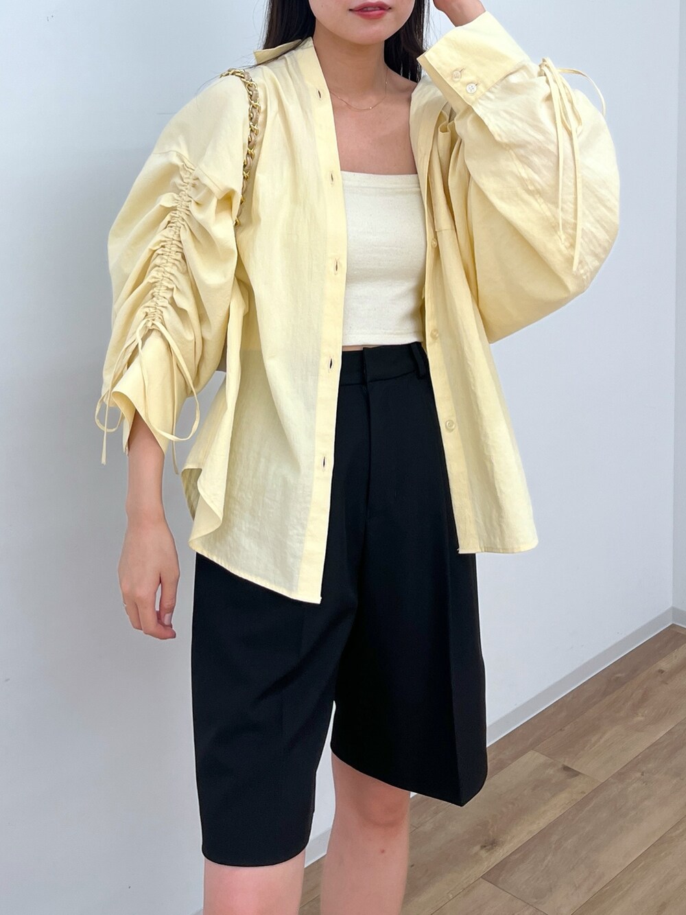 ブラック系のその他パンツ、イエロー系のシャツ/ブラウスを着用したレディースの春コーディネートの2枚目の写真