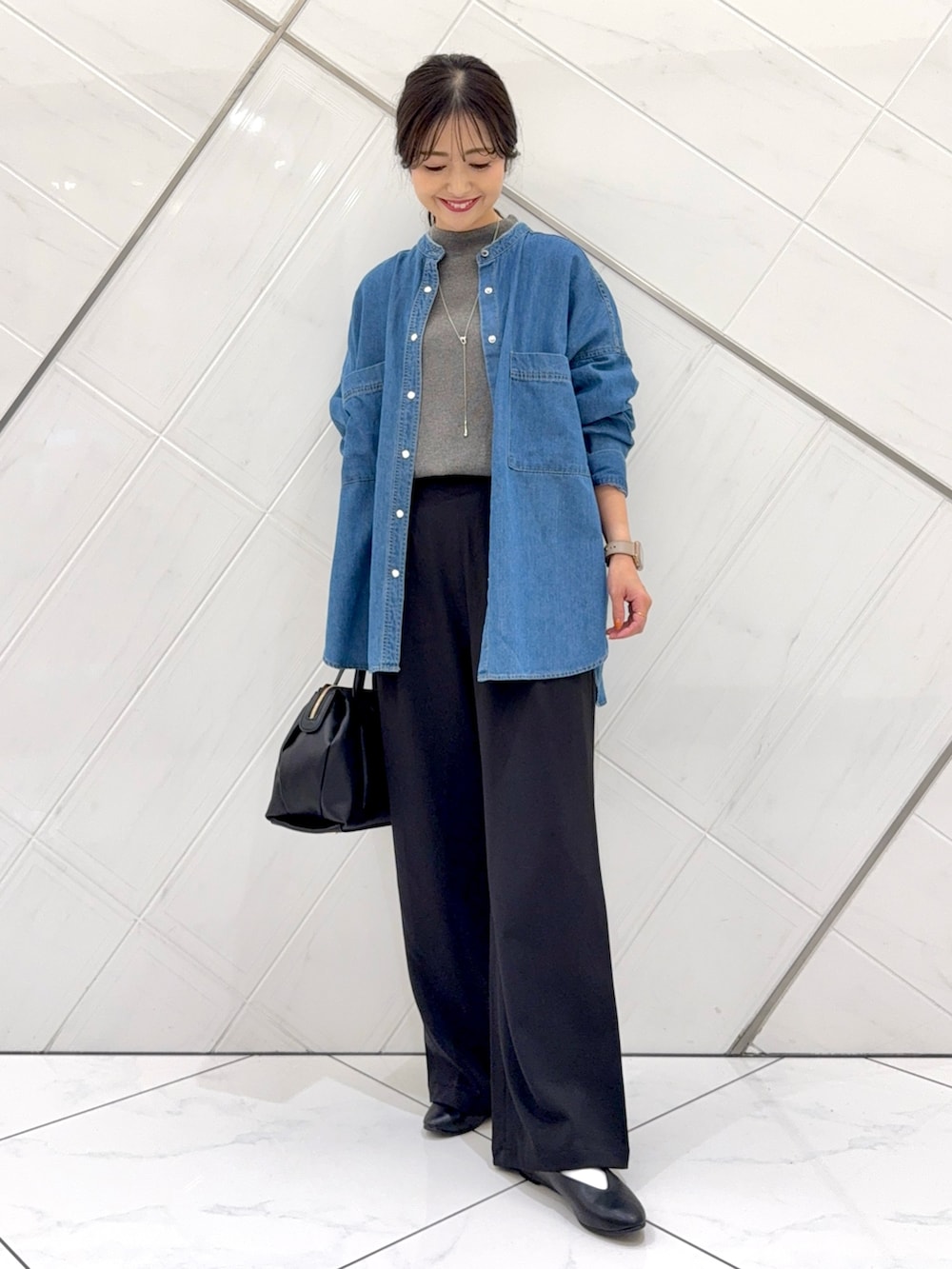 ブルー系のシャツ/ブラウス、グレー系のニット/セーター、ブラック系のその他パンツを着用したレディースの秋コーディネートの2枚目の写真