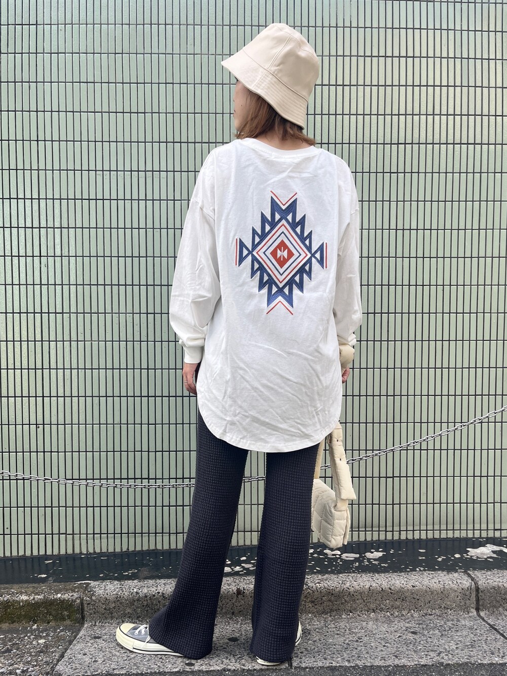 ホワイト系のTシャツ/カットソー、グレー系のその他パンツ、ホワイト系のショルダーバッグを着用したレディースの秋コーディネートの2枚目の写真