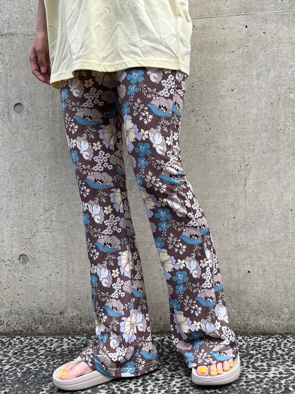 イエロー系のTシャツ/カットソー、ベージュ系のトートバッグ、ベージュ系のサンダルを着用したレディースの夏コーディネートの5枚目の写真