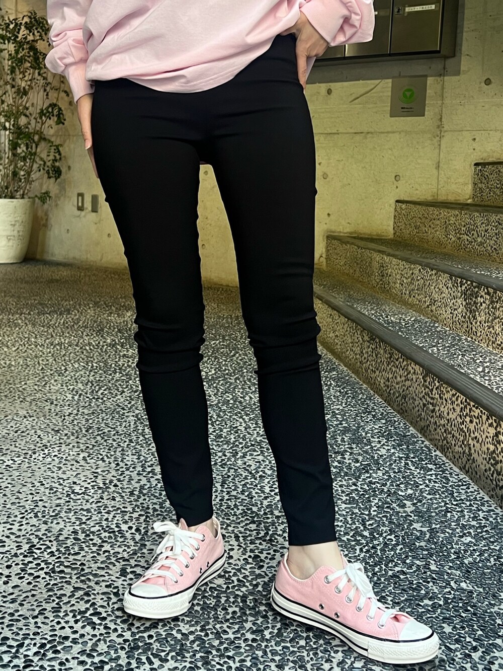ピンク系のTシャツ/カットソー、ホワイト系のショルダーバッグ、ブラック系のレギンス/スパッツを着用したレディースの春コーディネートの4枚目の写真