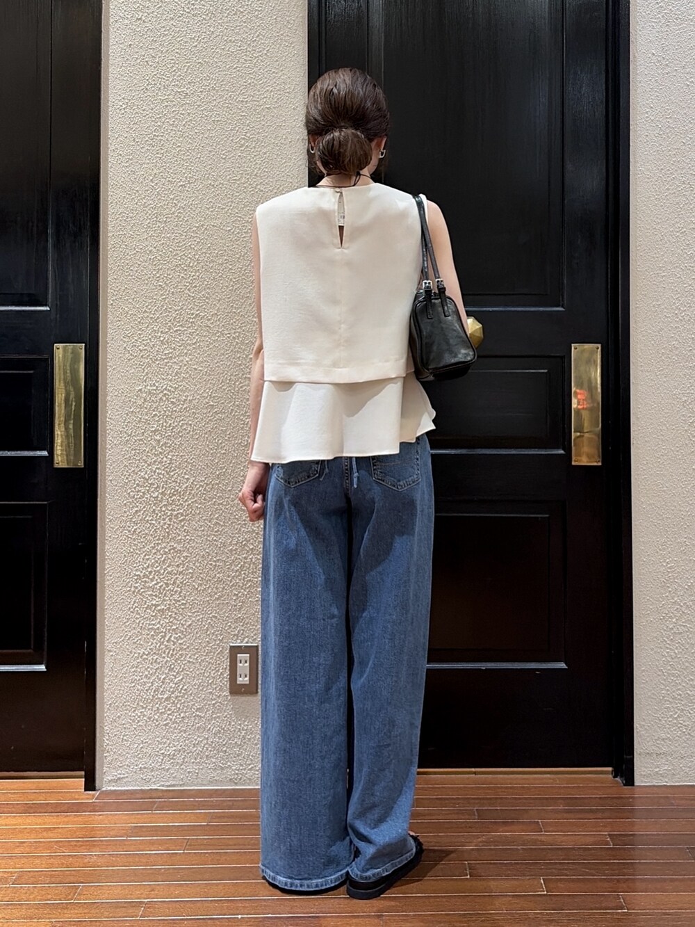 ブルー系のデニムパンツ、ベージュ系のシャツ/ブラウス、ブラック系のサンダルを着用したレディースの夏コーディネートの4枚目の写真