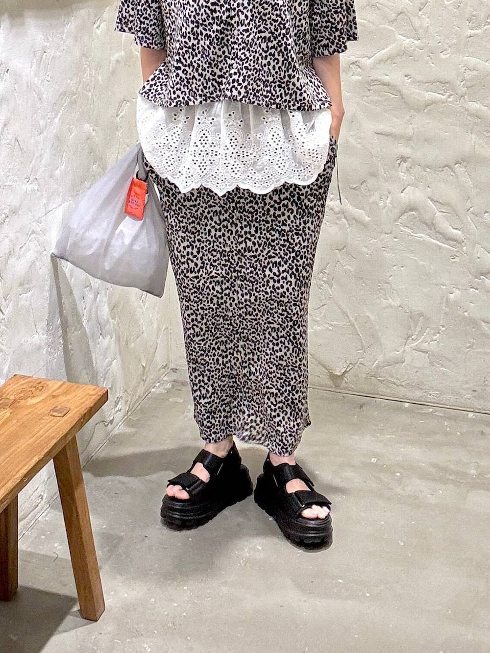 ホワイト系のシャツ/ブラウス、ホワイト系のスカート、ブラック系のサンダルを着用したレディースの夏コーディネートの3枚目の写真