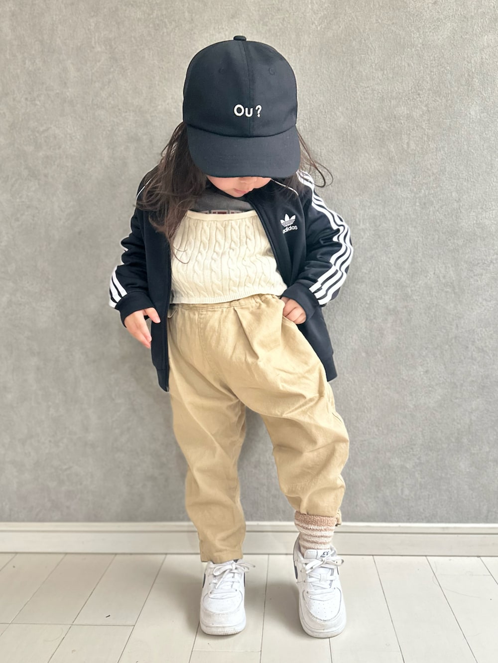 ブラック系のジャージ、グレー系のスウェット、ホワイト系のベストを着用したキッズの春コーディネートの2枚目の写真