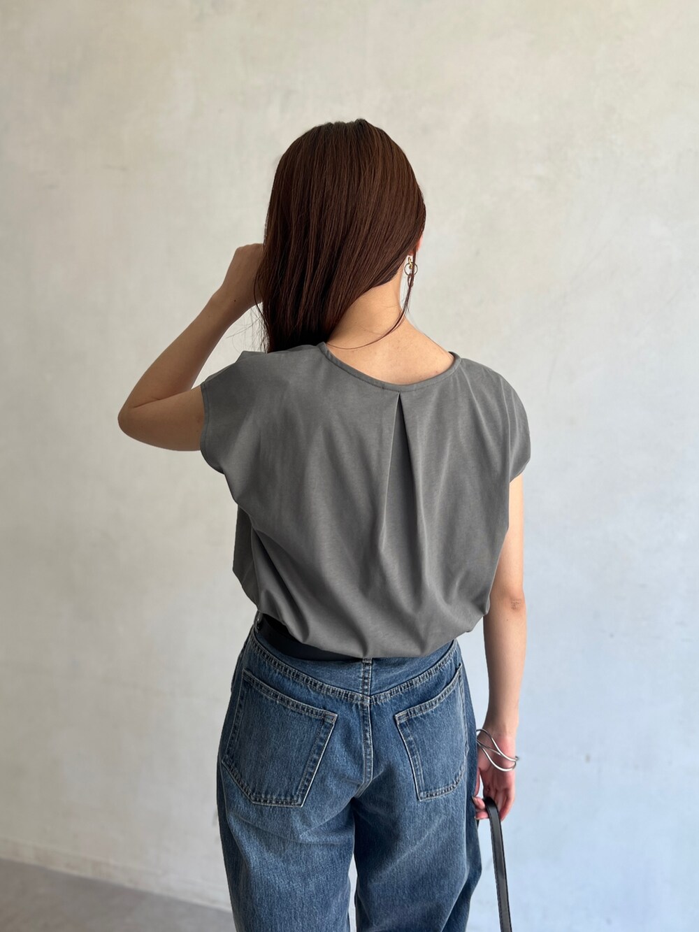グリーン系のTシャツ/カットソー、ブルー系のデニムパンツ、シルバー系のピアス（両耳用）を着用したレディースの夏コーディネートの5枚目の写真