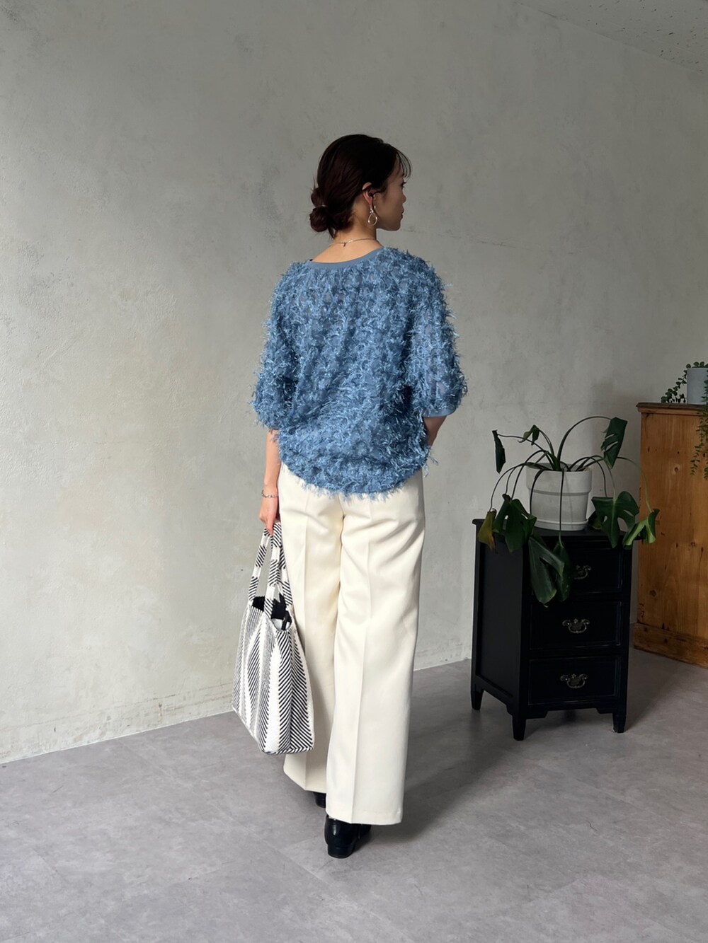 ブルー系のシャツ/ブラウス、ホワイト系のその他パンツ、ブラック系のトートバッグを着用したレディースの春コーディネートの2枚目の写真