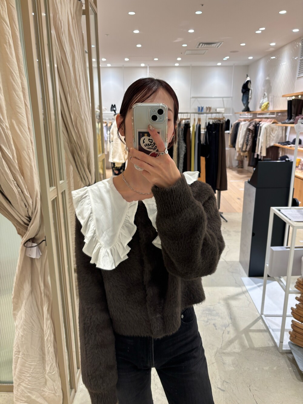 ホワイト系のシャツ/ブラウス、ブラック系のデニムパンツを着用したレディースの冬コーディネートの2枚目の写真