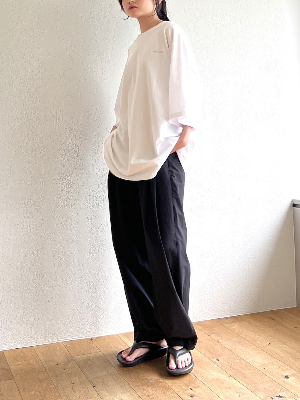 ホワイト系のTシャツ/カットソー、ブラック系のその他パンツ、ブラック系のサンダルを着用したレディースの夏コーディネートの4枚目の写真
