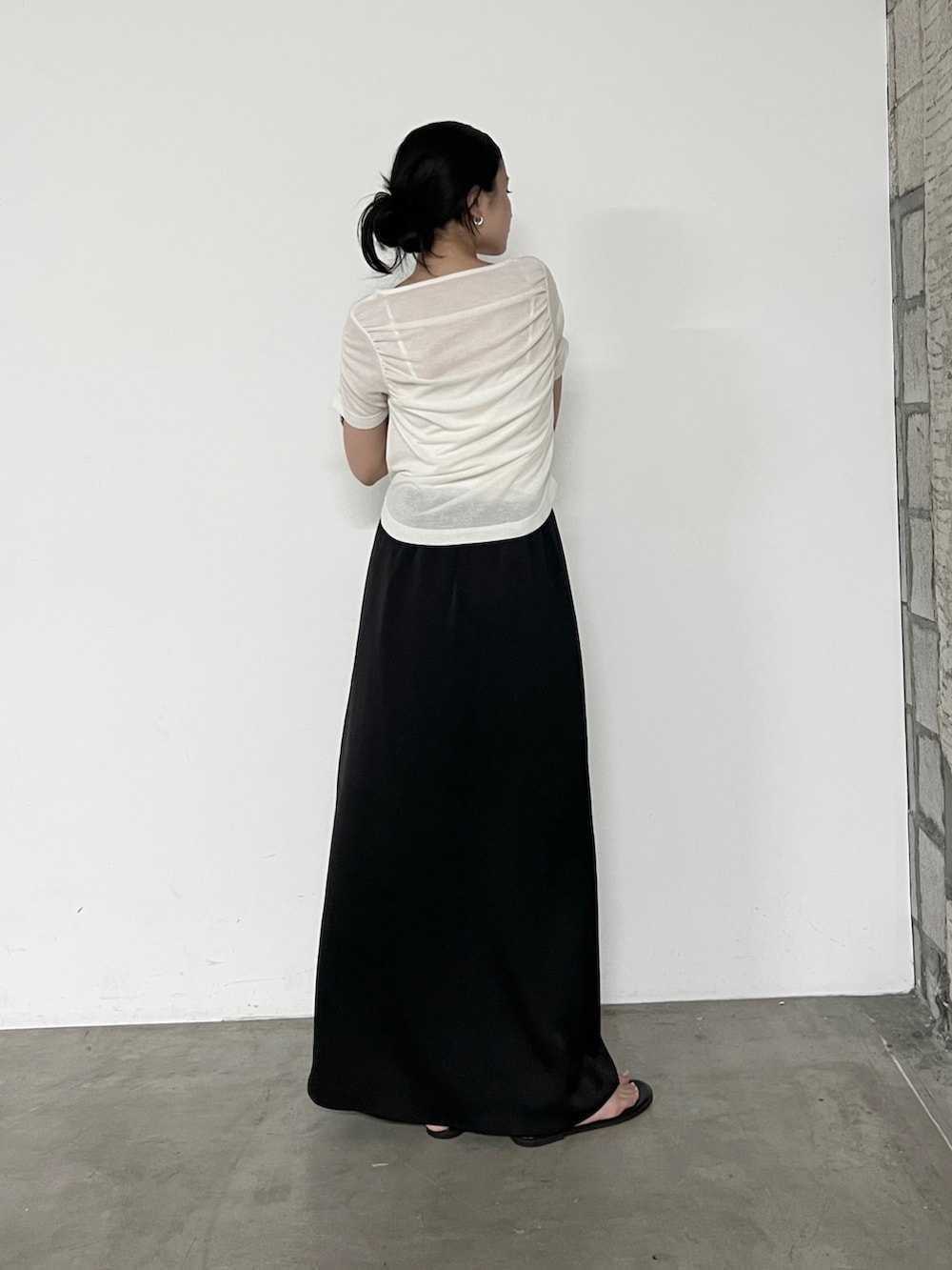 ホワイト系のTシャツ/カットソー、ブラック系のスカート、ブラック系のサンダルを着用したレディースの夏コーディネートの3枚目の写真
