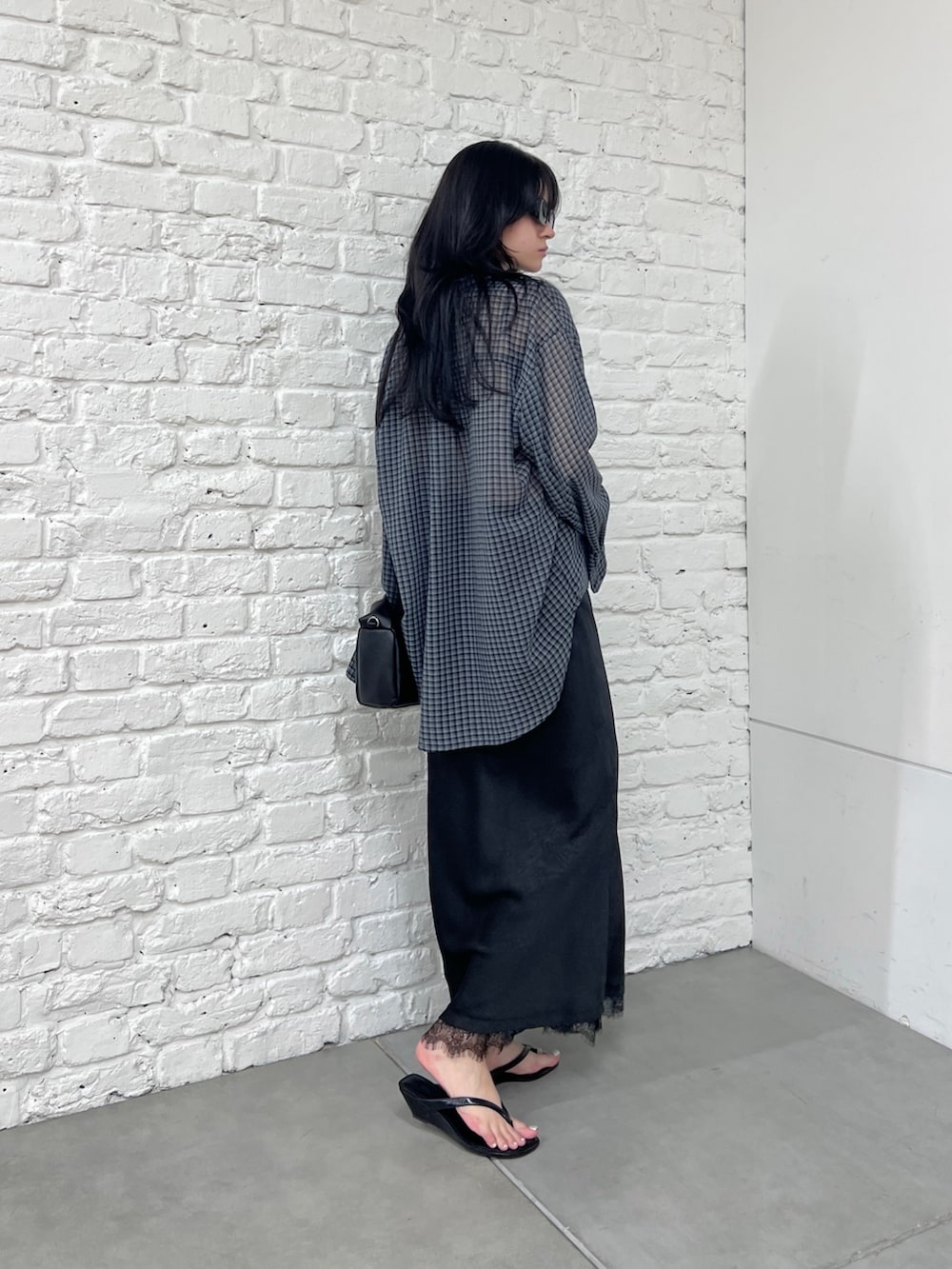 グレー系のシャツ/ブラウス、ブラック系のスカート、ブラック系のショルダーバッグを着用したレディースの夏コーディネートの4枚目の写真