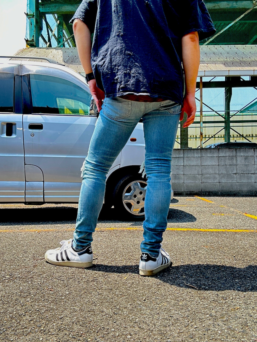 ホワイト系のスニーカー、ブラック系のTシャツ/カットソー、ブラック系のベルトを着用したメンズの春コーディネートの2枚目の写真