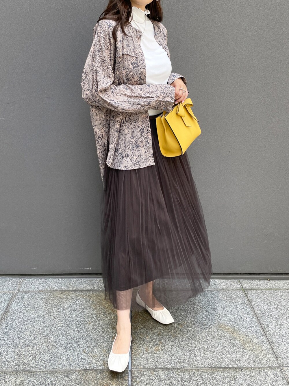 グレー系のシャツ/ブラウス、グレー系のスカート、ホワイト系のパンプスを着用したレディースの夏コーディネートの2枚目の写真