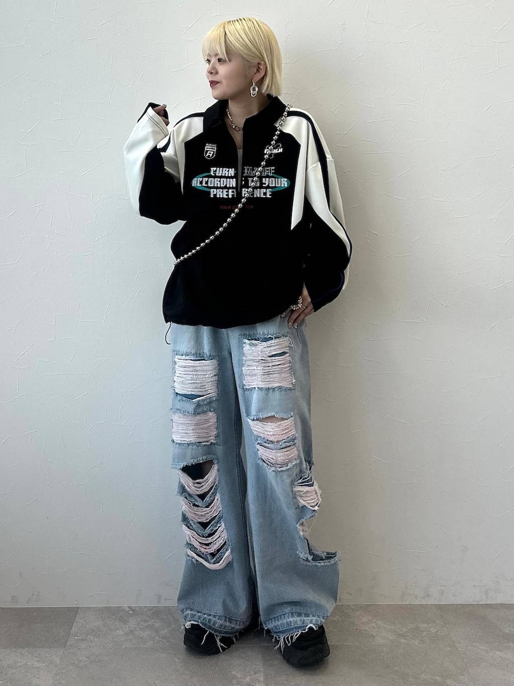 ブラック系のポロシャツを着用したレディースの冬コーディネートの2枚目の写真