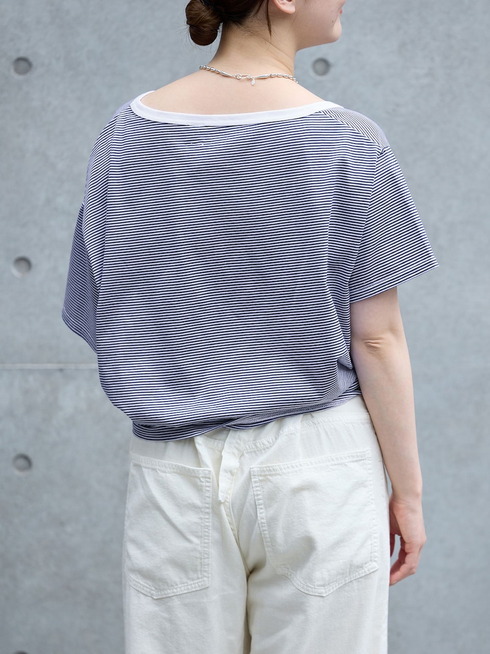 ホワイト系のチノパンツ、ブルー系のTシャツ/カットソー、ブラウン系のサンダルを着用したレディースの春コーディネートの4枚目の写真
