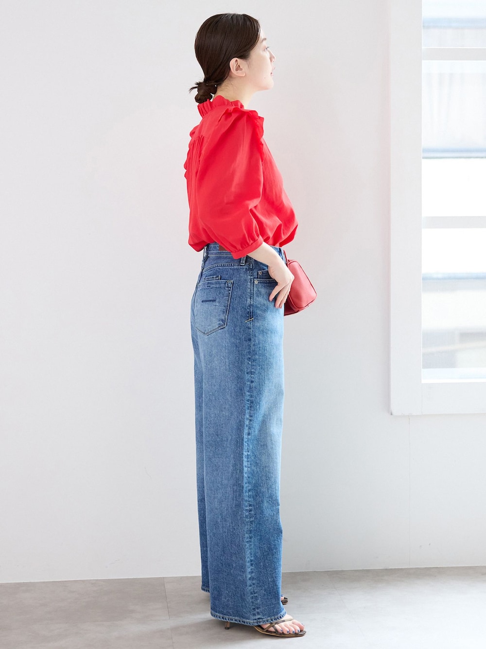 ブルー系のデニムパンツ、レッド系のシャツ/ブラウス、レッド系のショルダーバッグを着用したレディースの春コーディネートの2枚目の写真