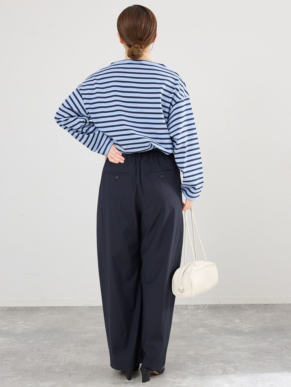 ブルー系のその他パンツ、ホワイト系のショルダーバッグを着用したレディースの春コーディネートの3枚目の写真