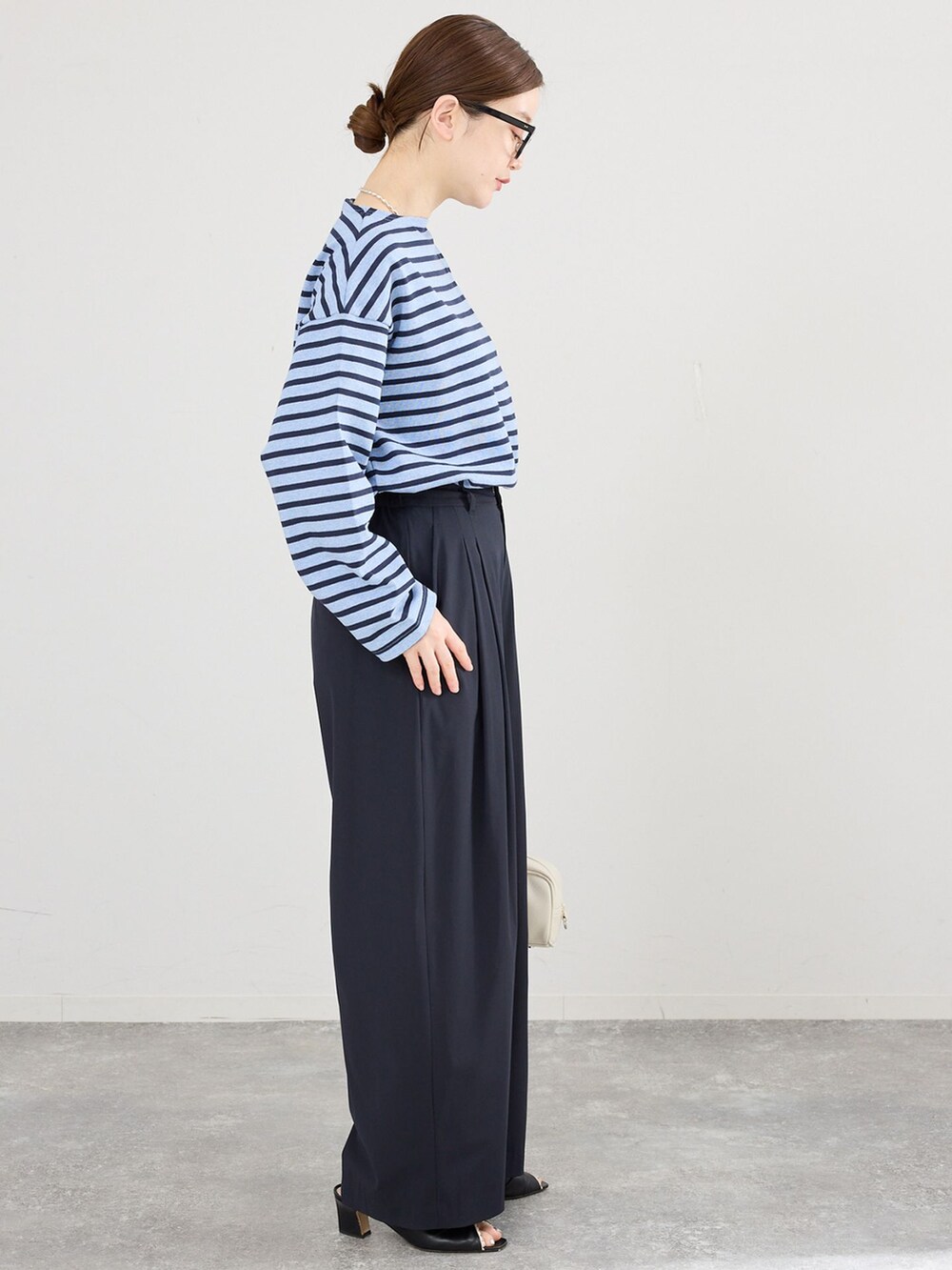 ブルー系のその他パンツ、ホワイト系のショルダーバッグを着用したレディースの春コーディネートの2枚目の写真