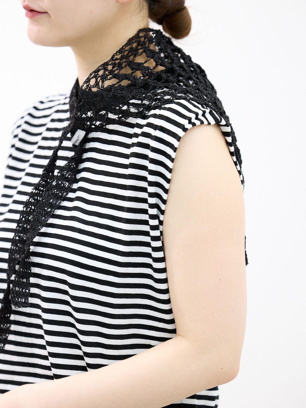 イエロー系のスカート、ブラック系のTシャツ/カットソー、ブラック系のサンダルを着用したレディースの春コーディネートの6枚目の写真