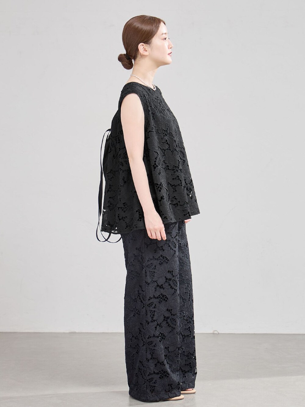 ブラック系のその他パンツ、ブラック系のシャツ/ブラウス、ブラック系のバックパック/リュックを着用したレディースの夏コーディネートの2枚目の写真