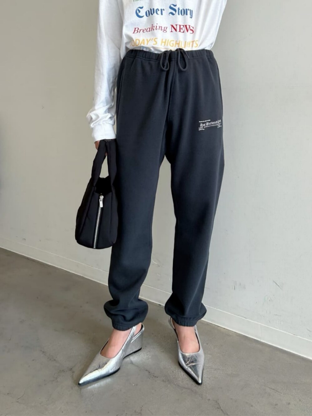 シルバー系のパンプス、ブラック系のトートバッグ、ブラック系のカーディガン/ボレロを着用したレディースの秋コーディネートの4枚目の写真