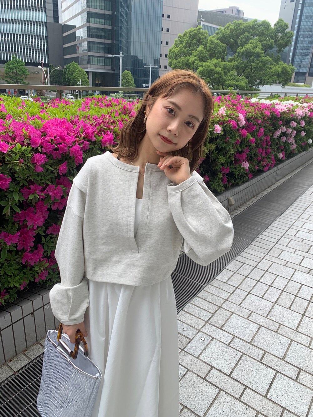 ホワイト系のワンピース、ブラック系のサンダルを着用したレディースの春コーディネートの2枚目の写真