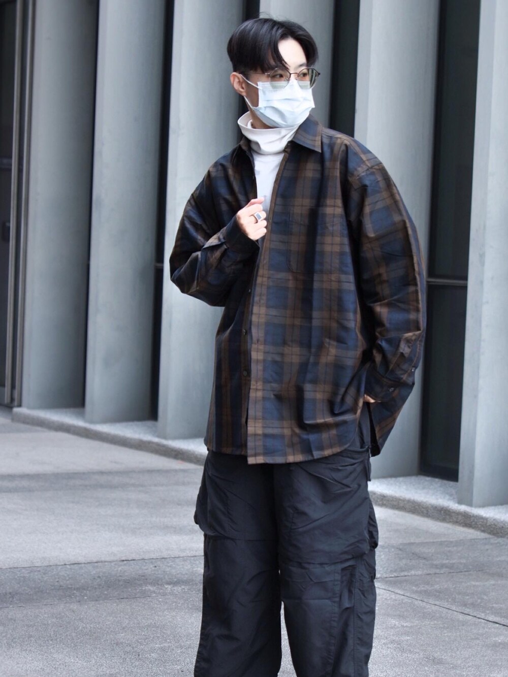 ブラック系のチノパンツ、ブラック系のスニーカー、ブラウン系のシャツ/ブラウスを着用したメンズの春コーディネートの2枚目の写真