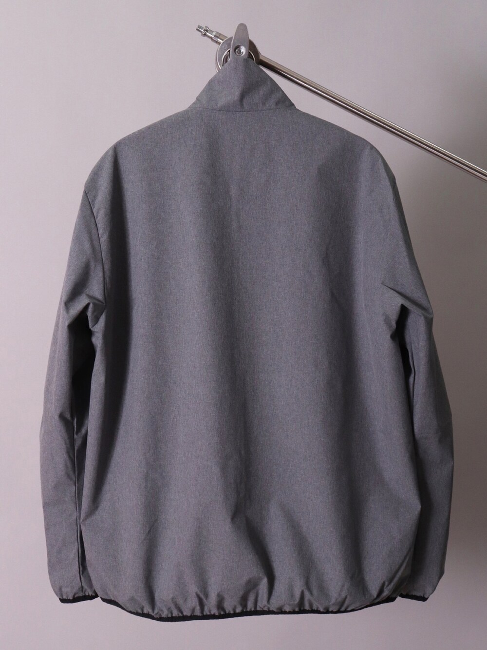 グレー系のナイロンジャケット、ブラック系のカーゴパンツ、ブラック系のナイロンジャケットを着用したレディースの冬コーディネートの5枚目の写真