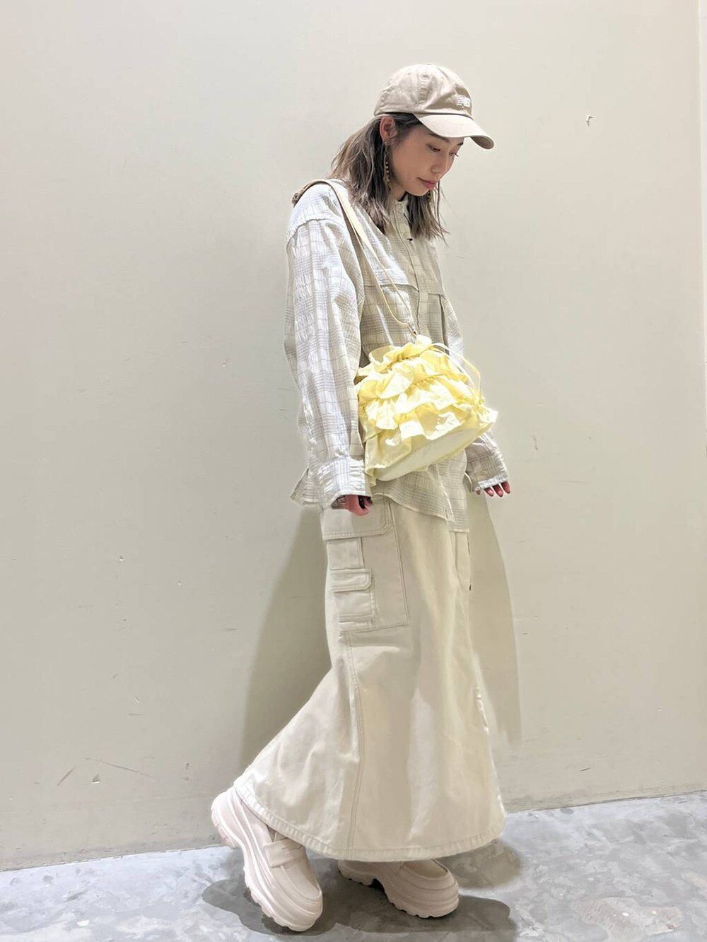 ベージュ系のローファー、ベージュ系のショルダーバッグ、ベージュ系のシャツ/ブラウスを着用したレディースの春コーディネートの2枚目の写真