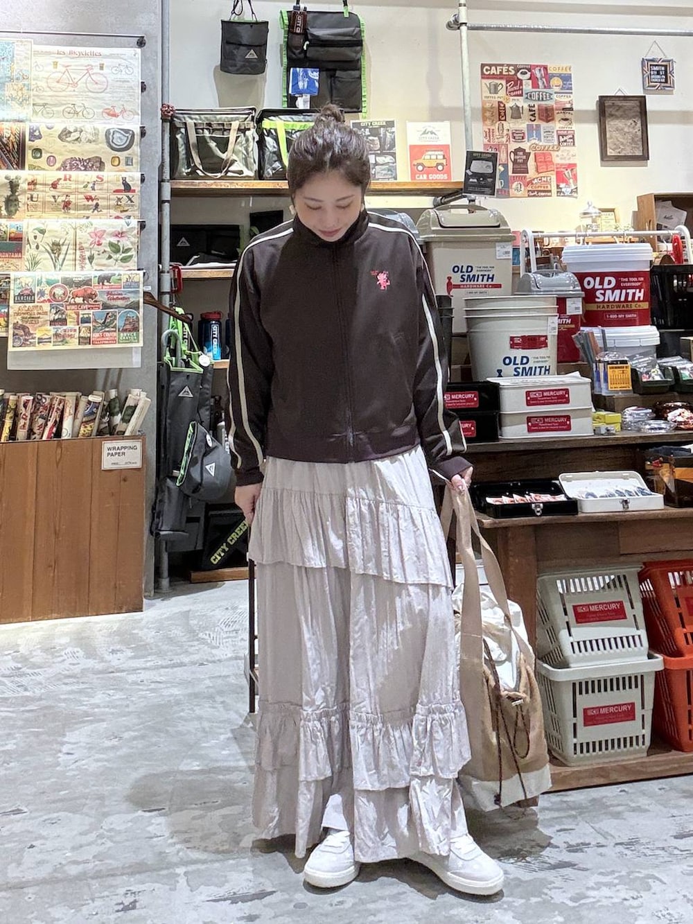 ブラウン系のジャージ、ベージュ系のトートバッグ、グレー系のスニーカーを着用したレディースの春コーディネートの5枚目の写真