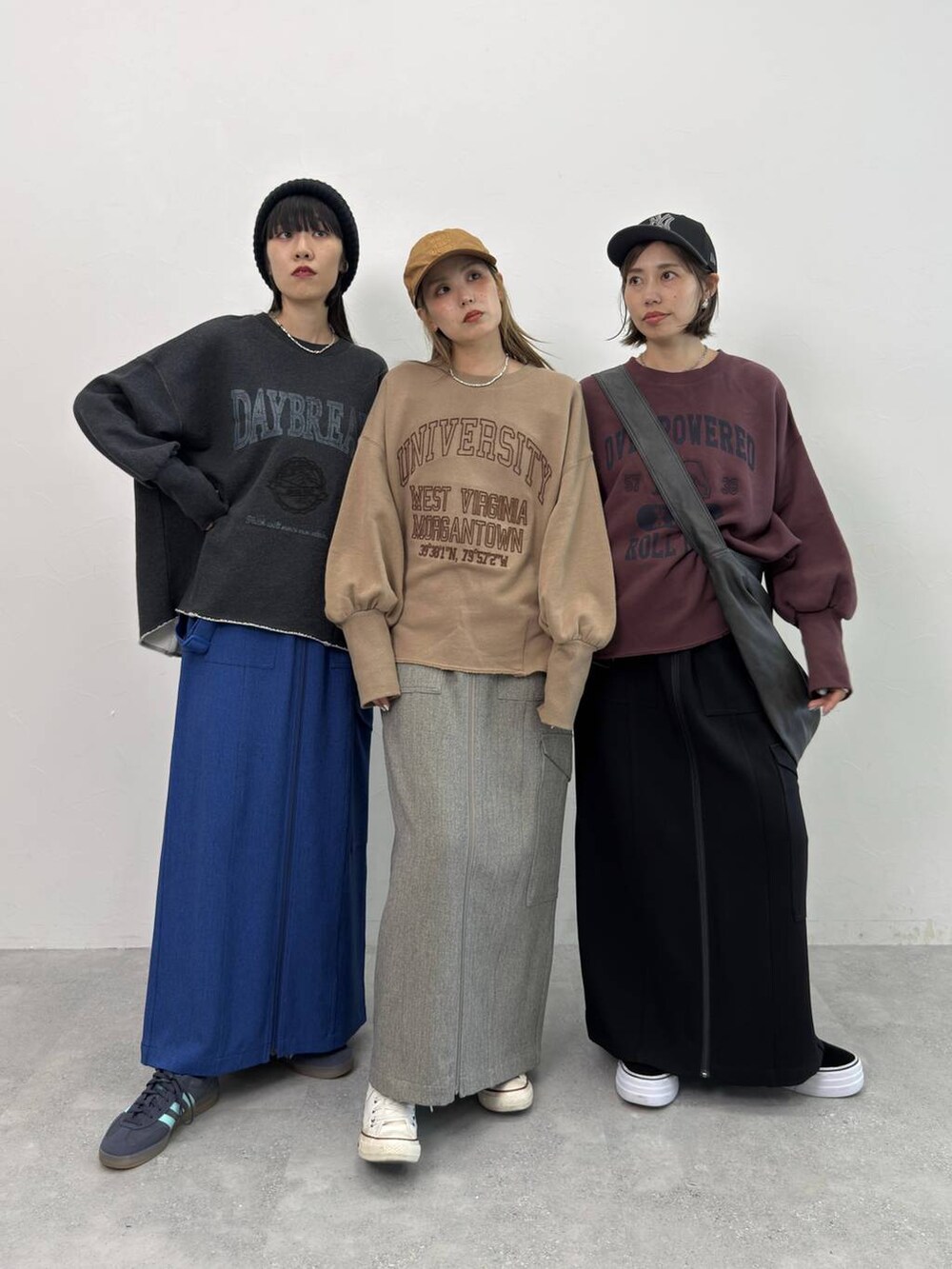 ブラック系のスカート、ブラック系のショルダーバッグ、レッド系のスウェットを着用したレディースの夏コーディネートの3枚目の写真