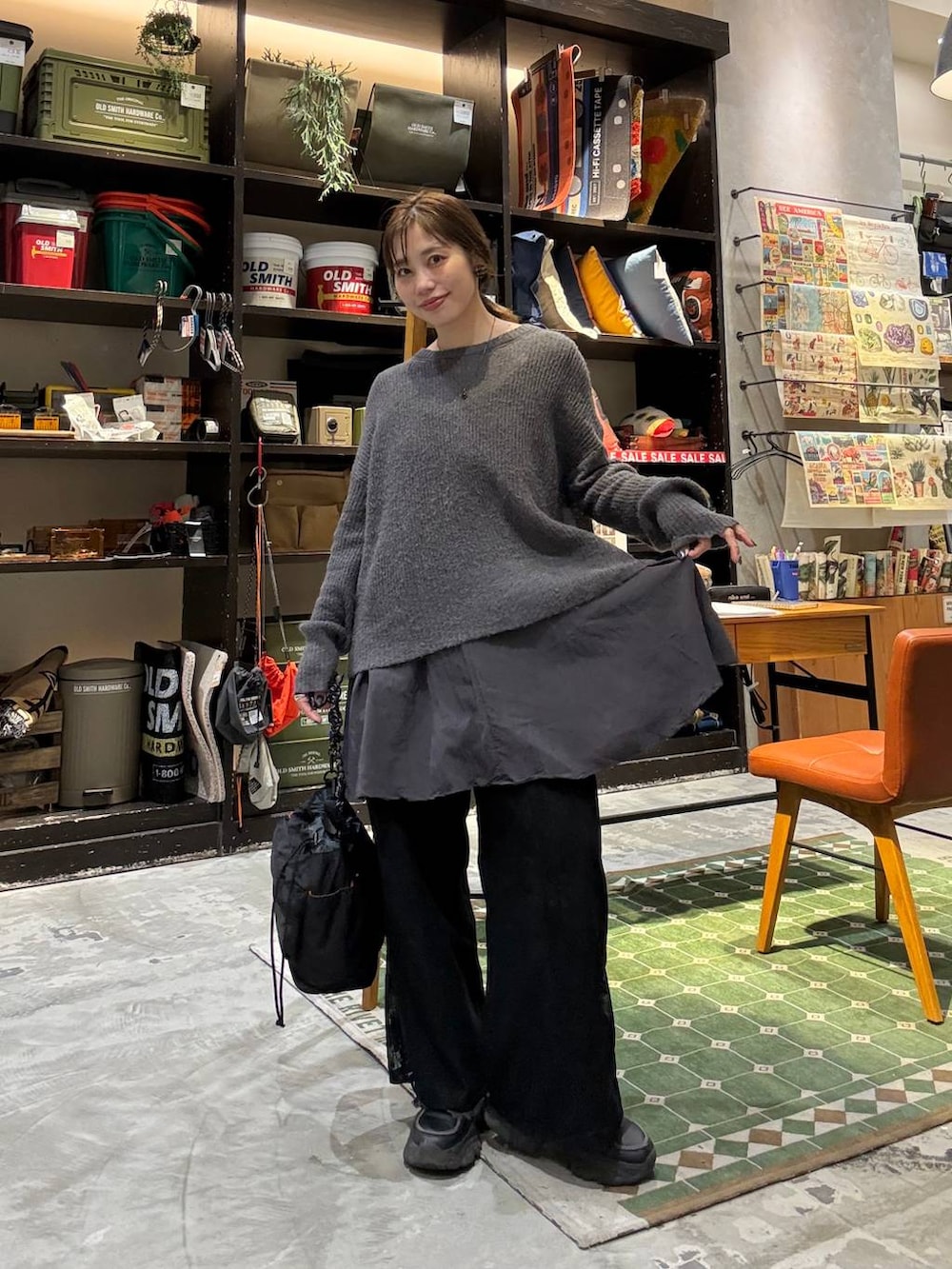 グレー系のニット/セーター、ブラック系のデニムパンツ、ブラック系のその他パンツを着用したレディースの冬コーディネートの4枚目の写真