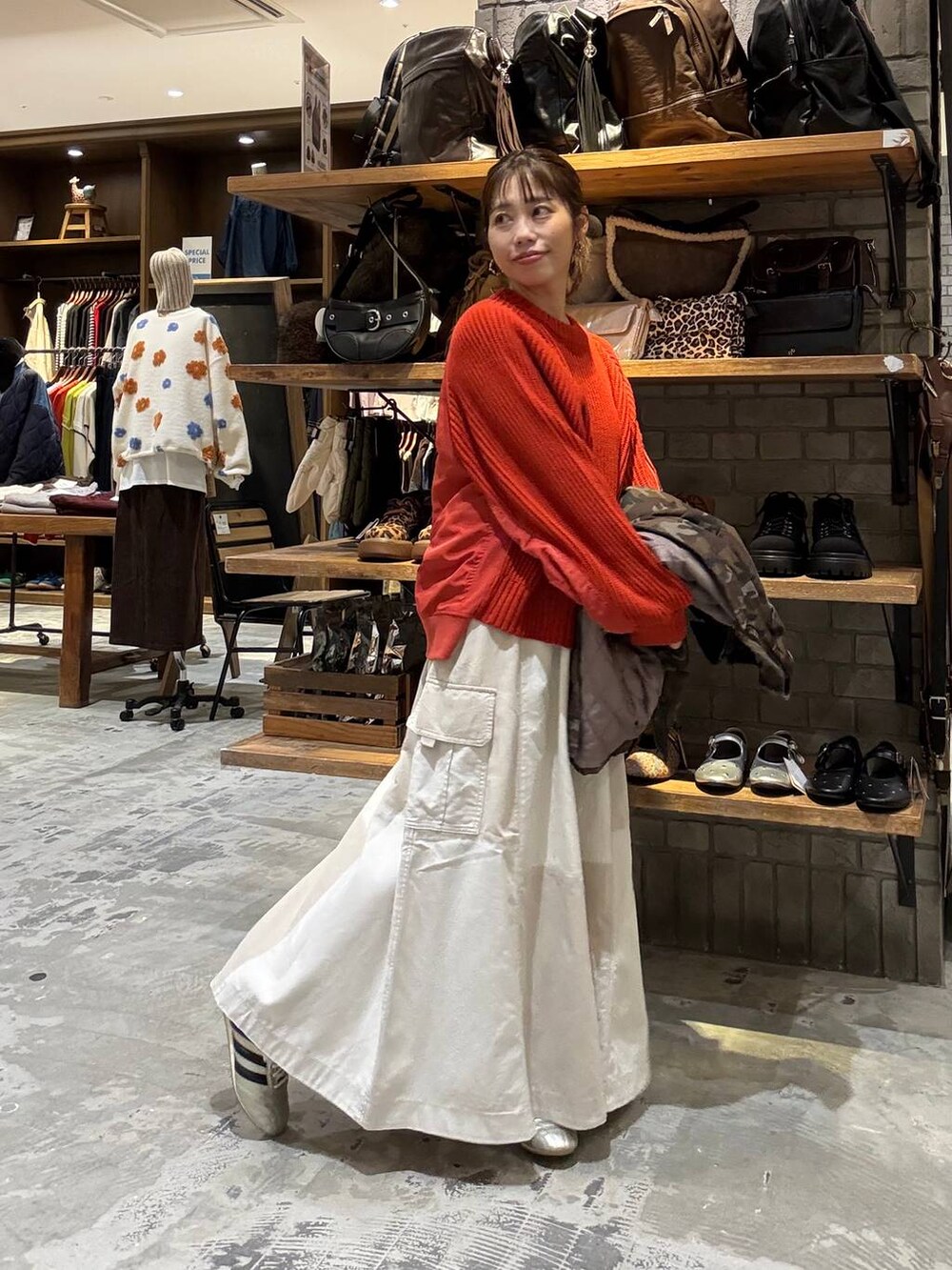 ゴールド系のスニーカー、ブラウン系のショルダーバッグ、レッド系のニット/セーターを着用したレディースの秋コーディネートの6枚目の写真