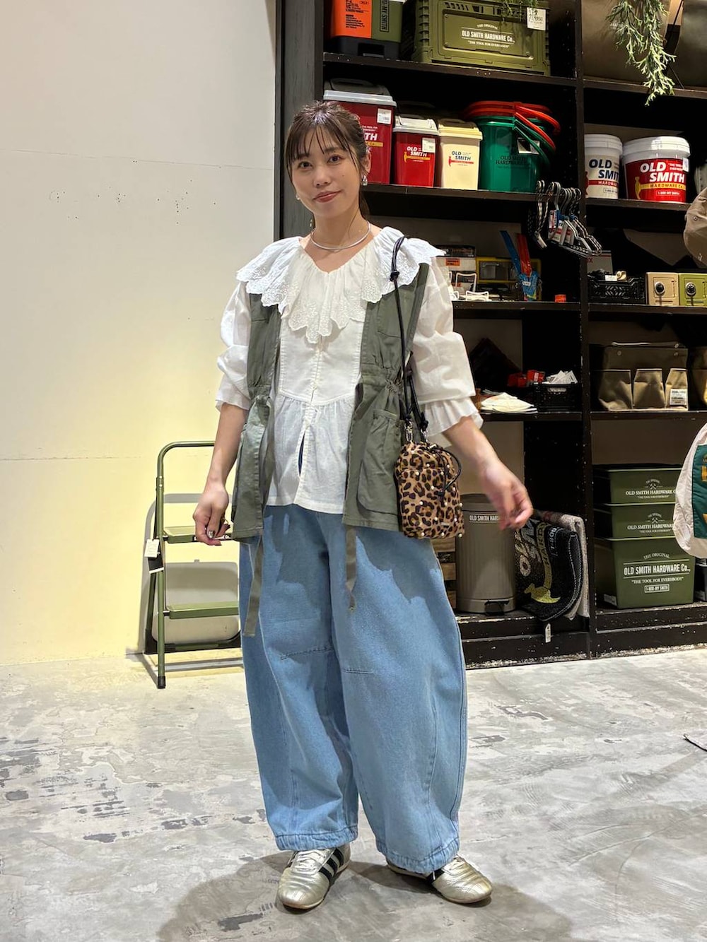 その他のショルダーバッグ、ゴールド系のスニーカー、グリーン系のベストを着用したレディースの冬コーディネートの7枚目の写真